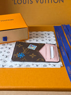 Small Louis Vuitton monogram pouch with pink interior card holder and colorful charm