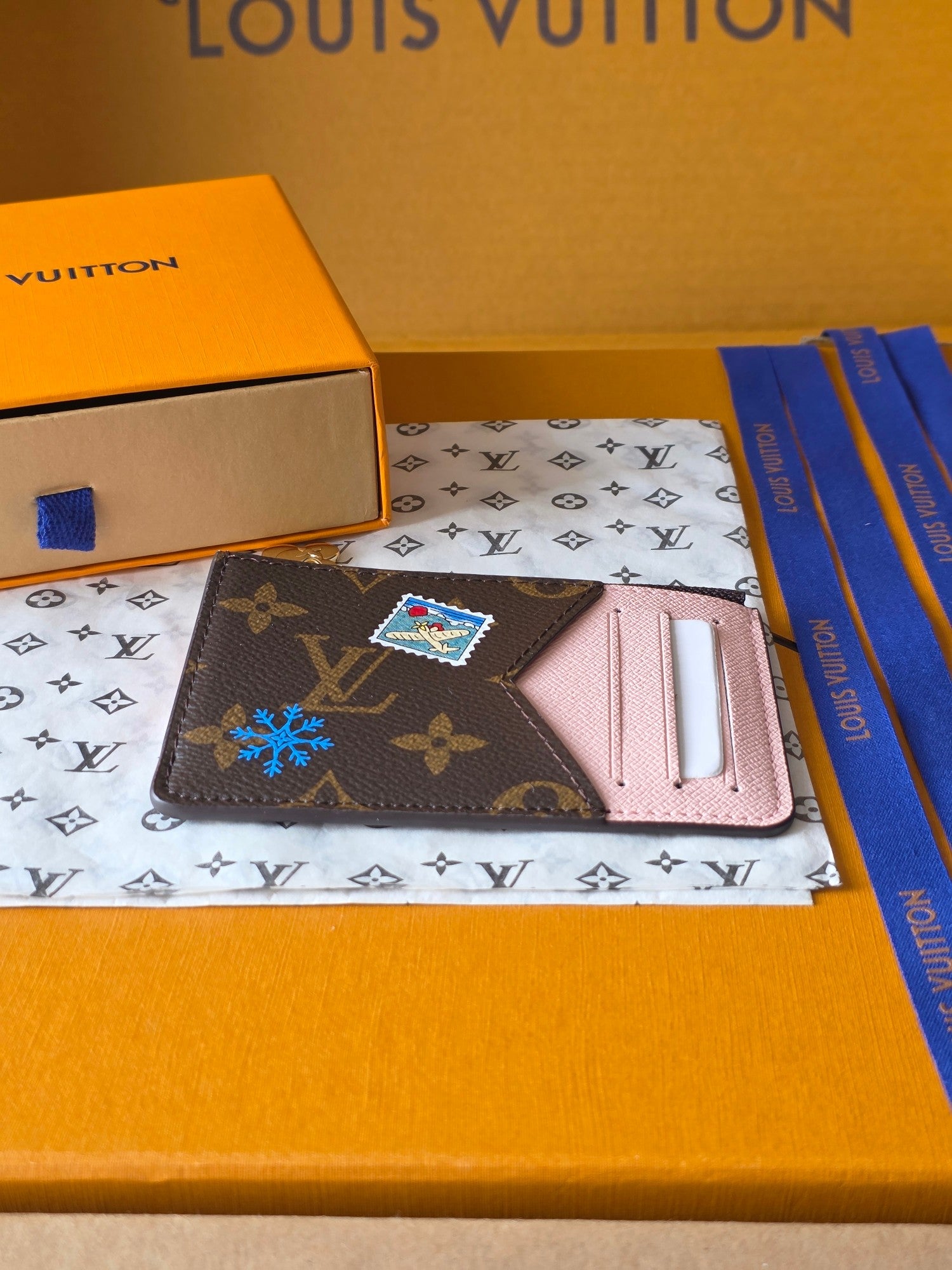 Small Louis Vuitton monogram pouch with pink interior card holder and colorful charm