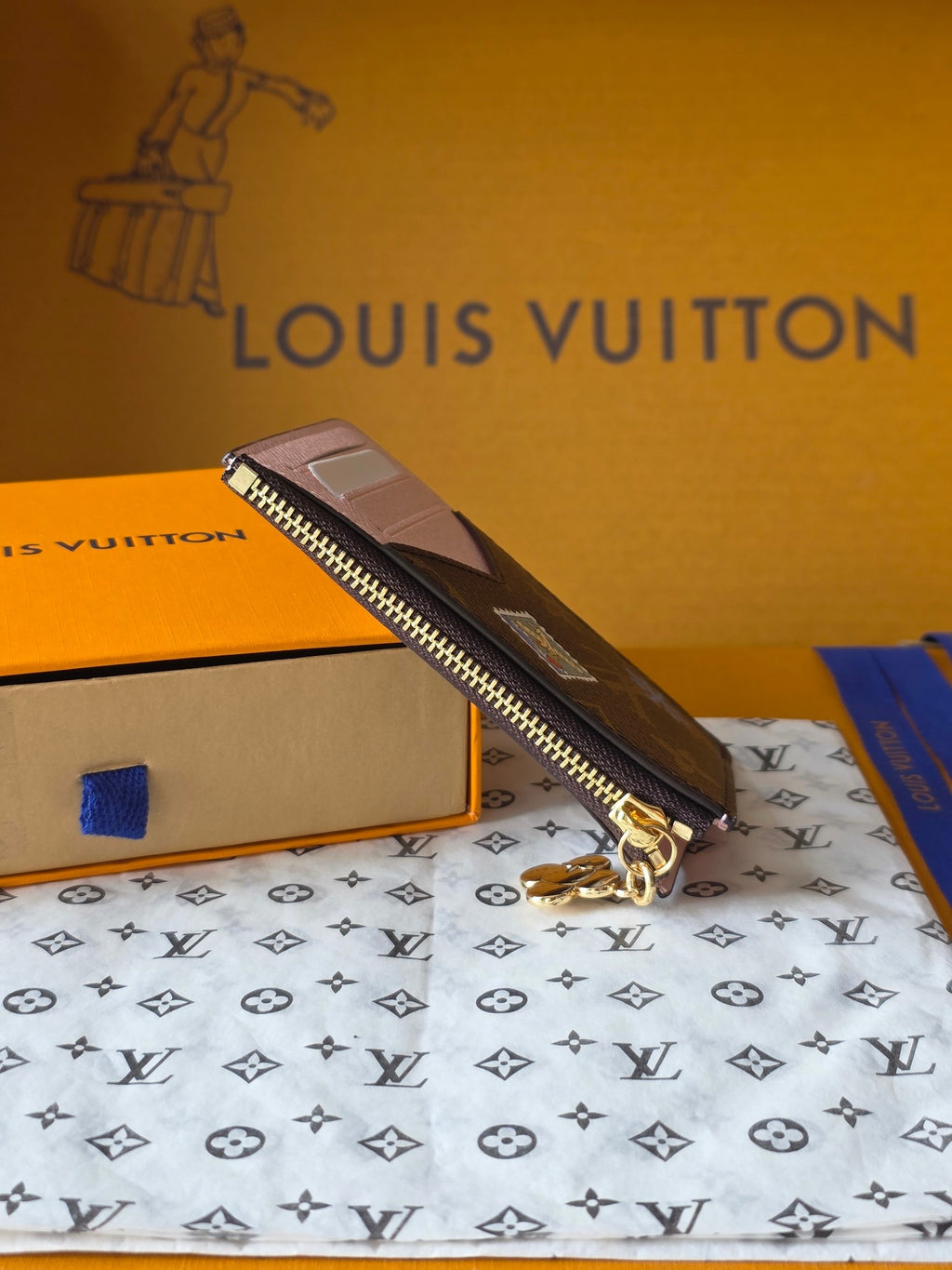Small Louis Vuitton monogram wristlet pouch with zipper and gold-tone keyring