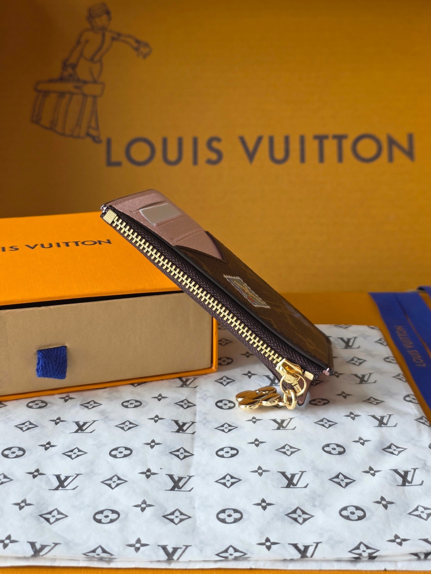 Small Louis Vuitton monogram wristlet pouch with zipper and gold-tone keyring