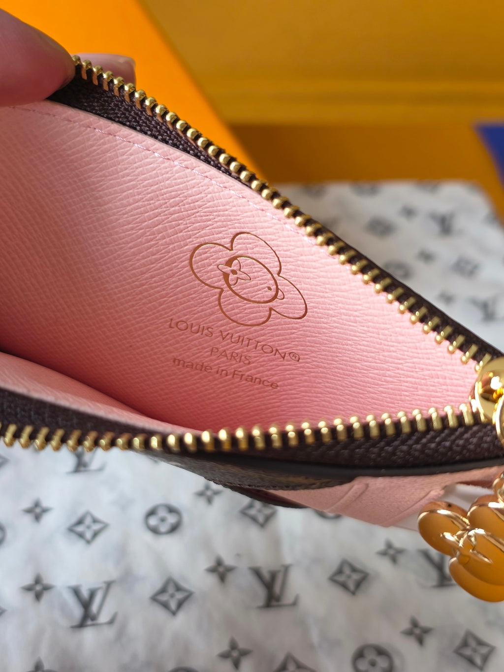 Small Louis Vuitton pink interior pouch with embossed logo and gold zipper edge