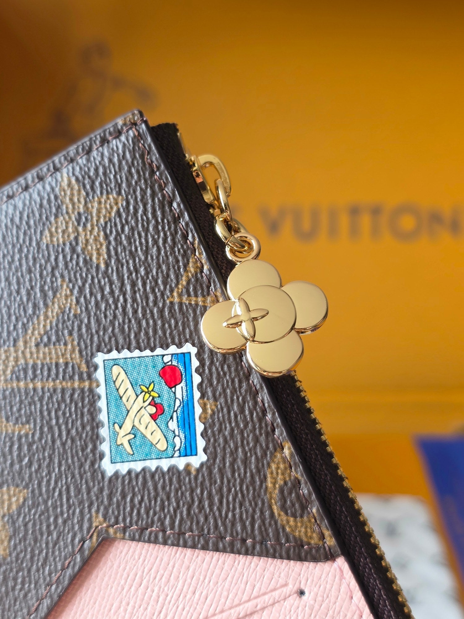 Small Louis Vuitton monogram pouch with gold clasp and Mickey-style key charm