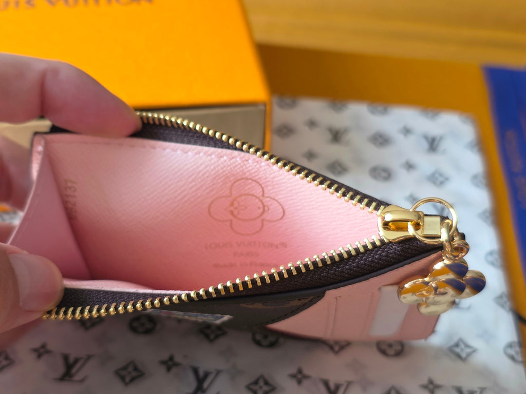 Small Louis Vuitton pink lining pouch with gold zipper and hanging key charm