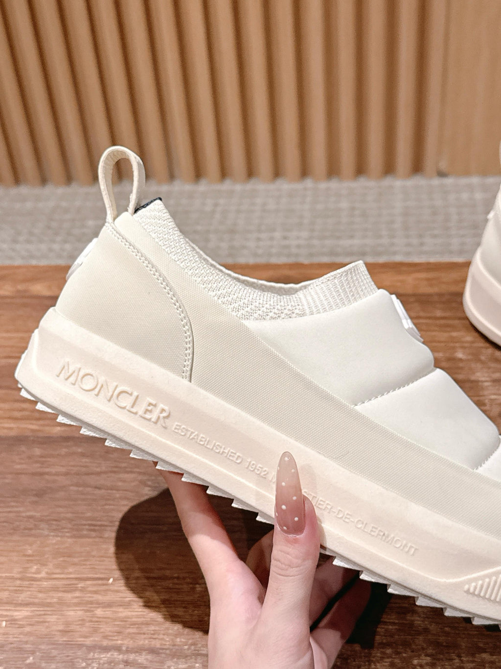 Moncler white slip-on sneaker close-up, textured platform sole detail