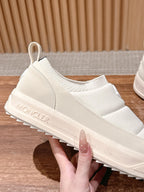 Moncler white slip-on sneaker close-up, textured platform sole detail