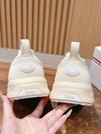 Moncler white slip-on sneakers back view, heel label and side logos