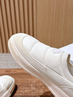 Moncler white slip-on sneaker close-up, side panel and stitched trim