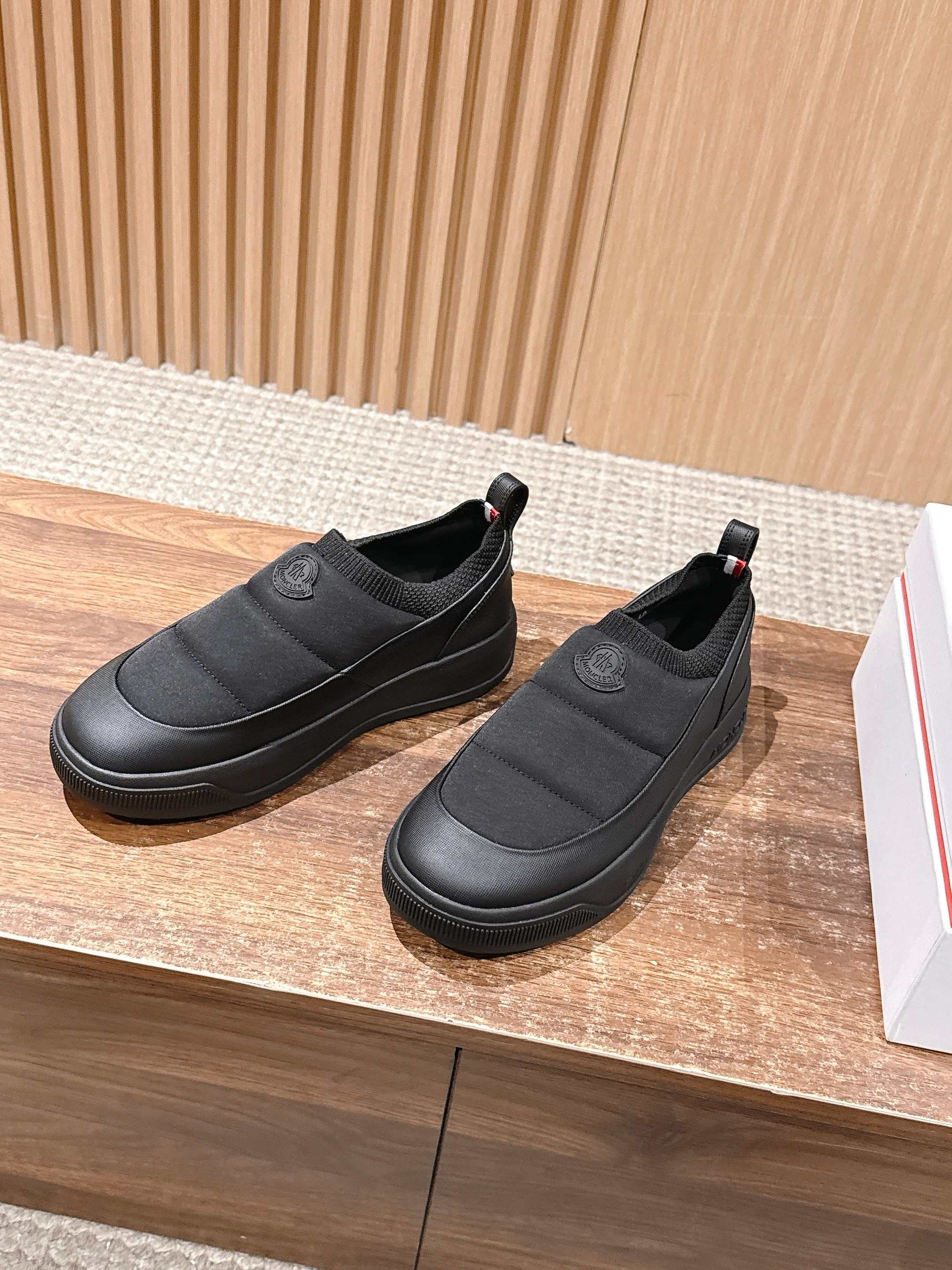 Moncler slip-on shoes in dark gray with cushioned upper and logo patch