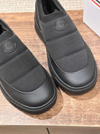 Moncler slip-on shoes in dark gray with ribbed toe and embossed heel logo