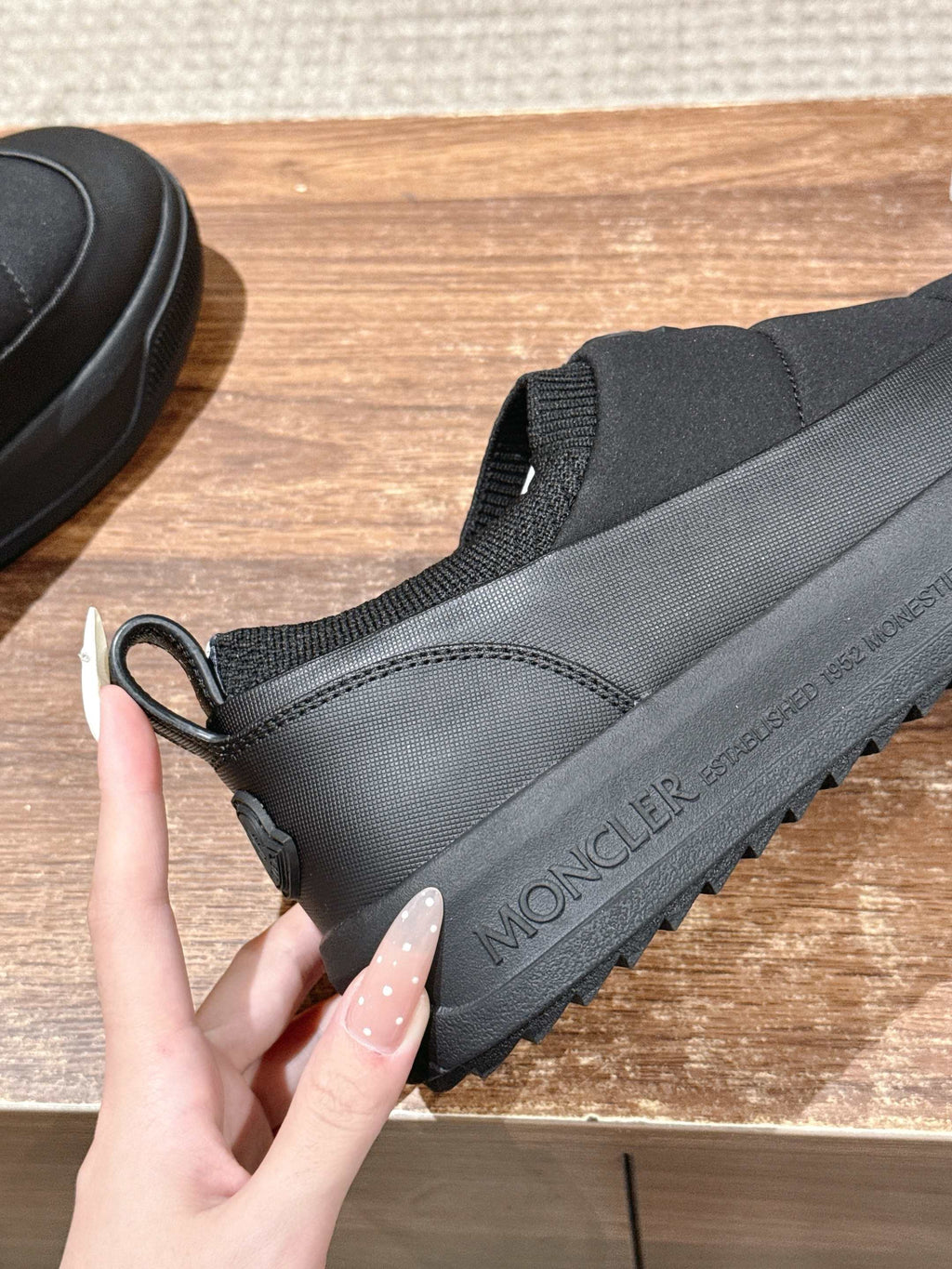 Moncler slip-on shoe in dark gray with logo text on side and loop pull tab