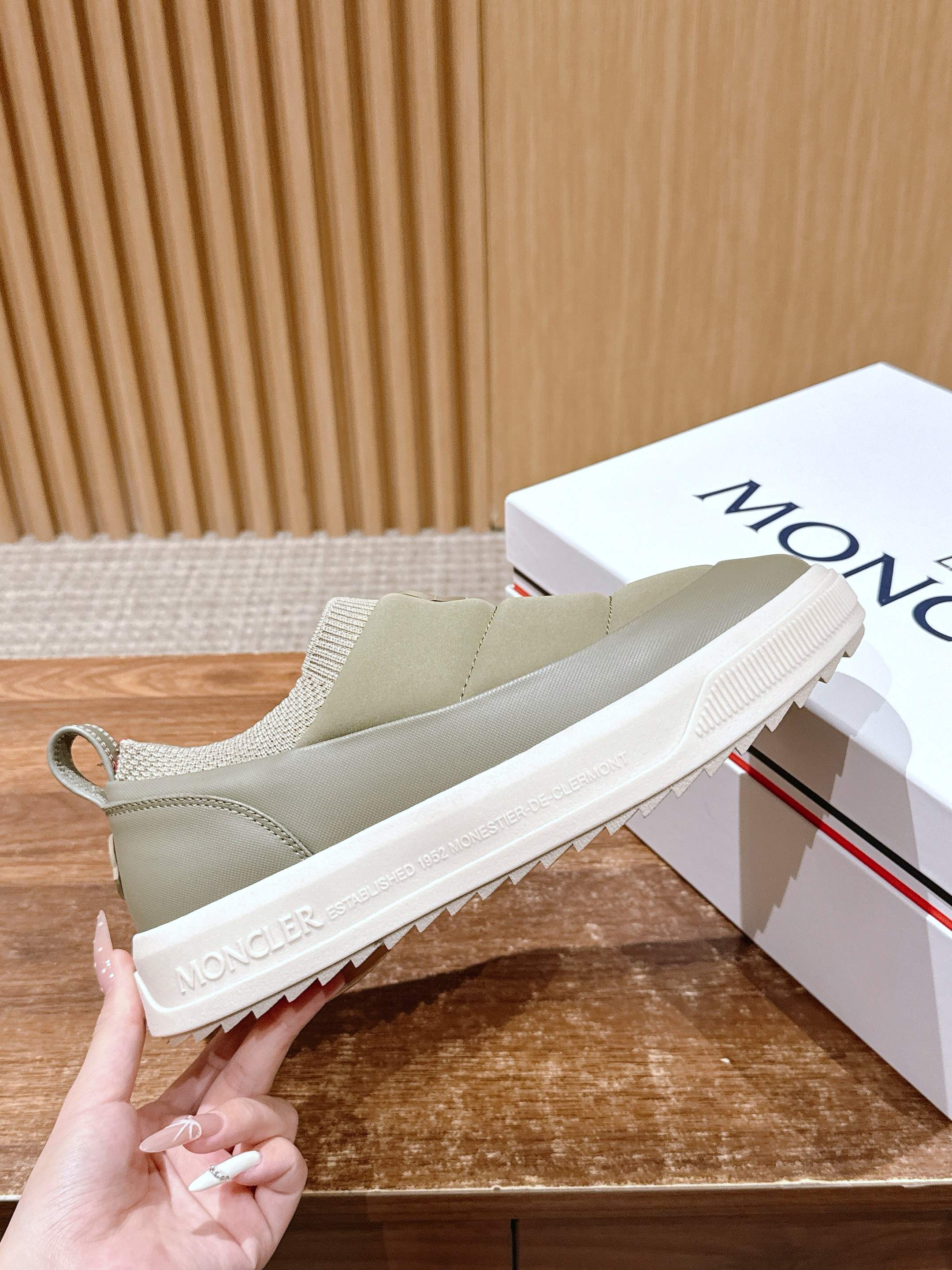 Moncler light beige slip-on sneaker showing textured white sole edge and stitched upper