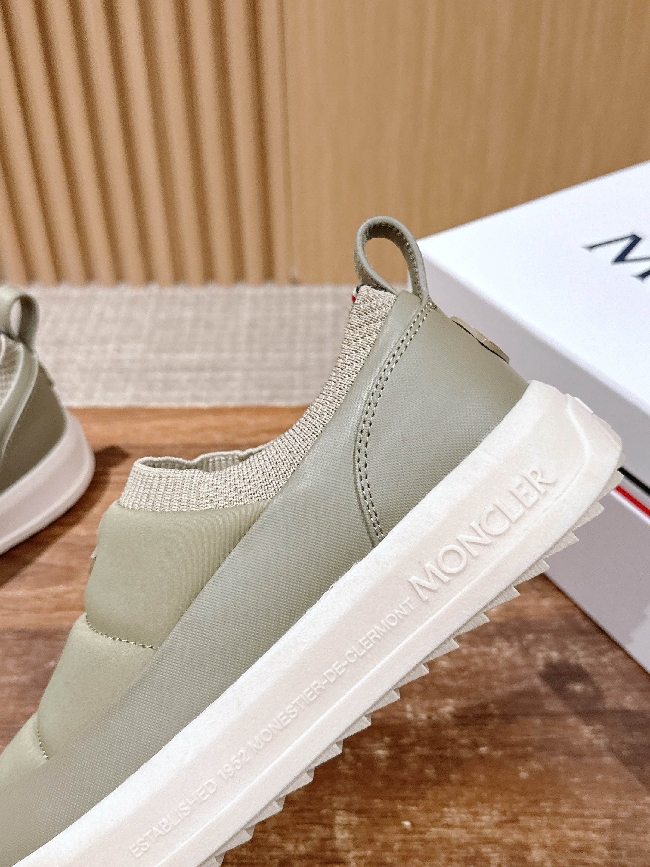Light beige Moncler slip-on sneaker with knit collar, elastic gore, and white tread sole