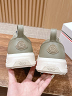 Moncler light beige sneakers heel view with white rubber sole and branding on back