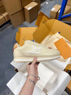 Low-top sneakers in cream leather with brown quarter panels and white logo detail