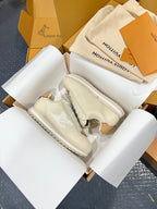 Cream low-top sneakers shown from the top view with tan accents and white rubber sole