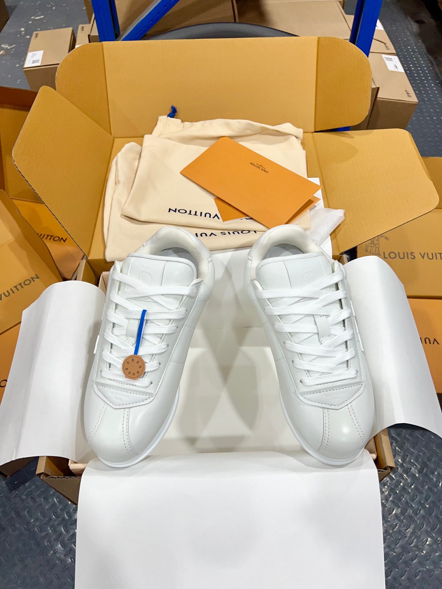 Louis Vuitton white leather sneakers, lace-up front with side stitching and round toe