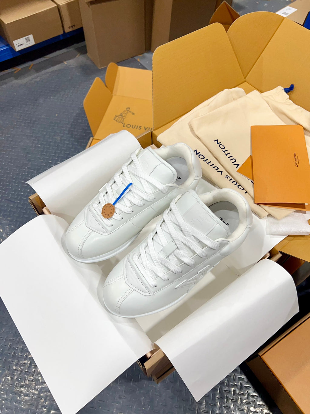Louis Vuitton white lace-up sneakers with textured sole and stitched quarter details