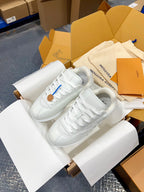 Louis Vuitton white lace-up sneakers with textured sole and stitched quarter details