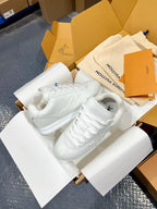 Louis Vuitton white sneakers with lace-up design and flat, padded collar
