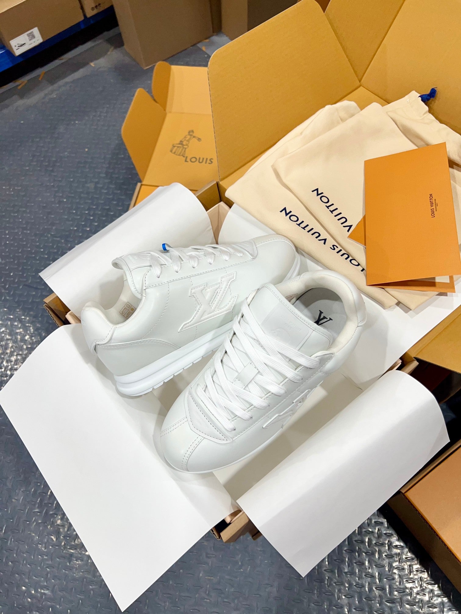 Louis Vuitton white sneakers with lace-up design and flat, padded collar