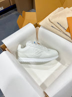 Louis Vuitton white lace-up sneakers with minimal branding on the side