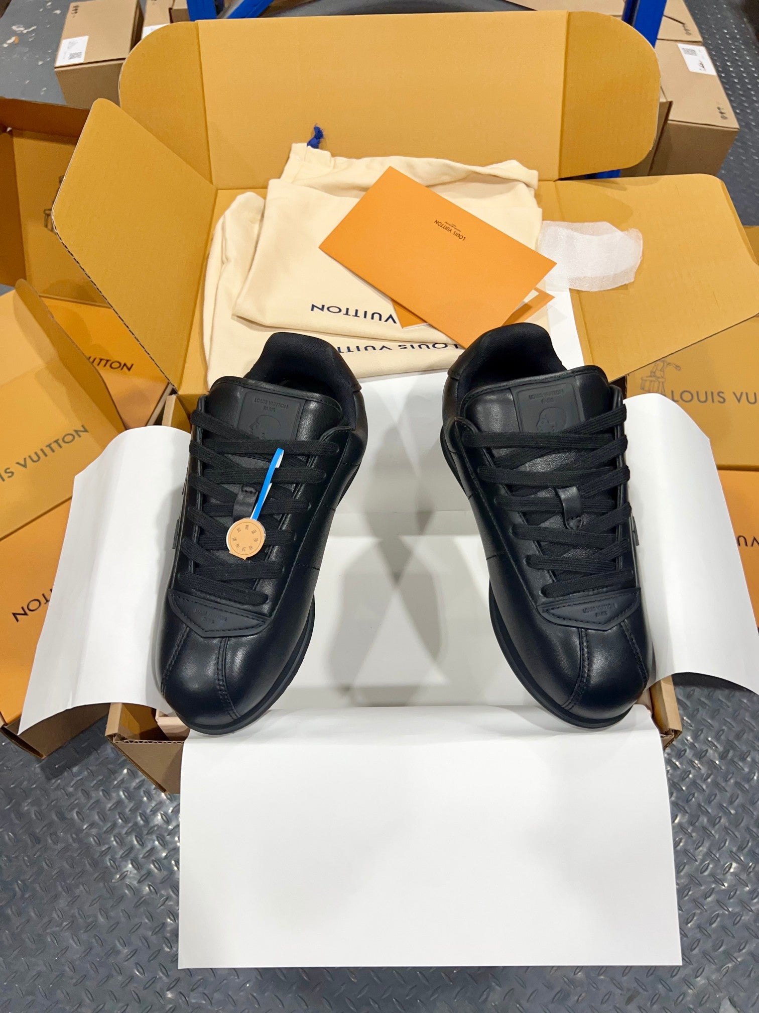 Black Louis Vuitton lace-up sneakers with lace-up panels and side logo, front view