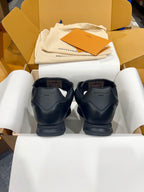 Back view of black Louis Vuitton lace-up sneakers with heel branding and rubber sole
