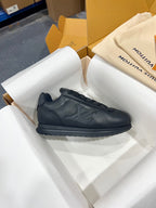 Black Louis Vuitton low-top sneaker with embossed logo and textured rubber outsole