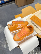 Louis Vuitton unisex sneakers orange leather with white LV logo, laid in open shoe box