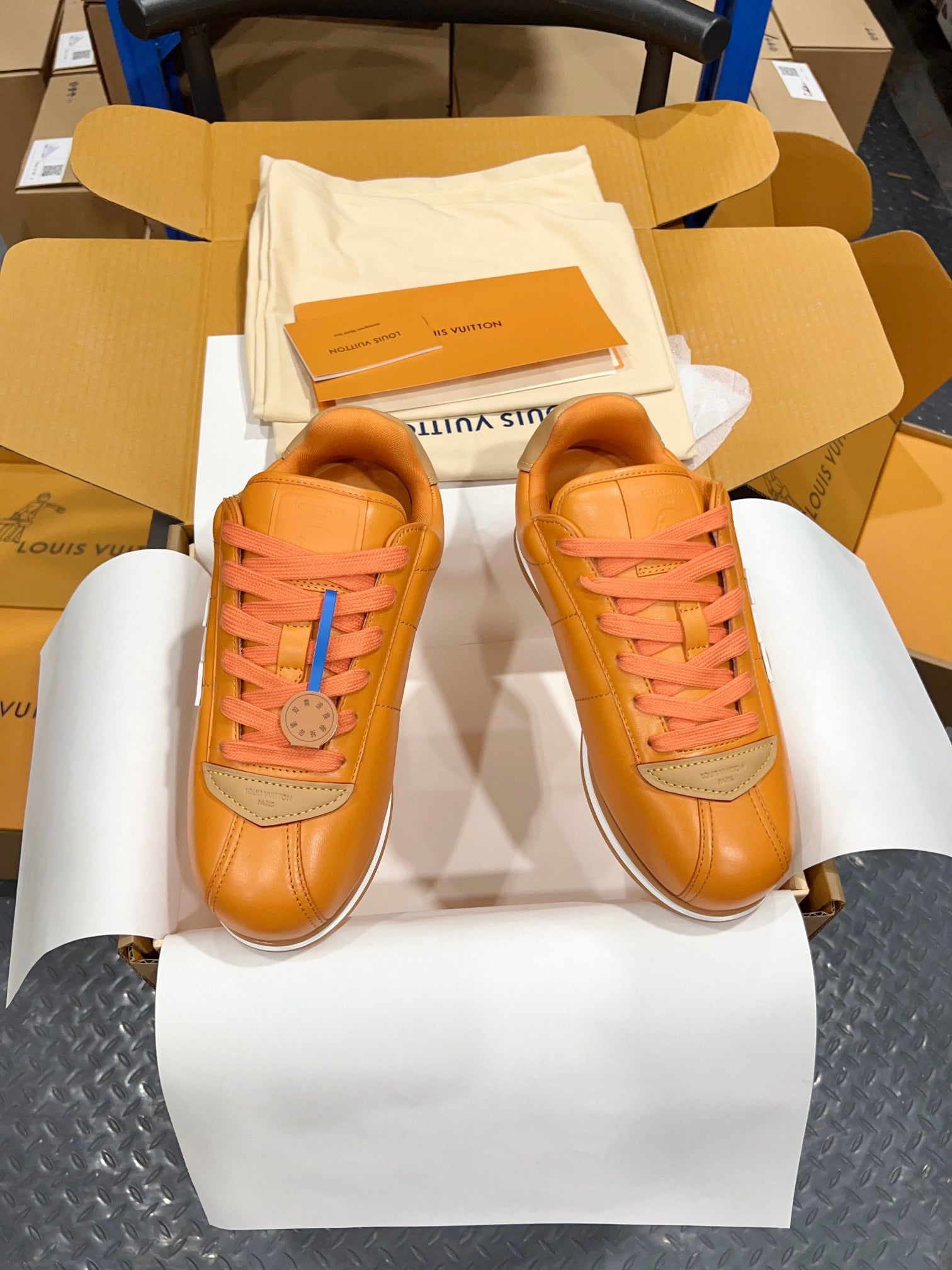 Louis Vuitton unisex sneakers orange leather with pink laces and blue lace accents, front view