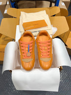 Louis Vuitton unisex sneakers pair in orange with blue lace accents and white soles