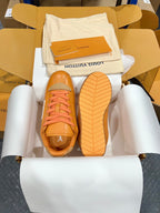 Louis Vuitton unisex sneakers outsole view, orange shoes with tread and blue lace accents