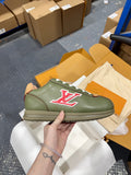 Green leather sneaker with white laces and red LV logo, tan heel trim