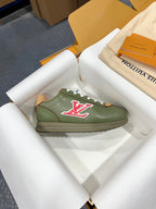 Green leather low-top sneaker with white laces and red LV logo
