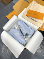 Light blue sneakers viewed from above with blue rubber sole and lace-up uppers