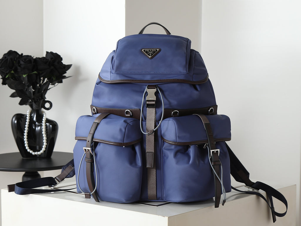 Prada blue nylon backpack with top flap and front pockets, dual straps