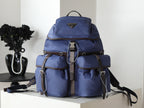 Prada blue nylon backpack with top flap and front pockets, dual straps