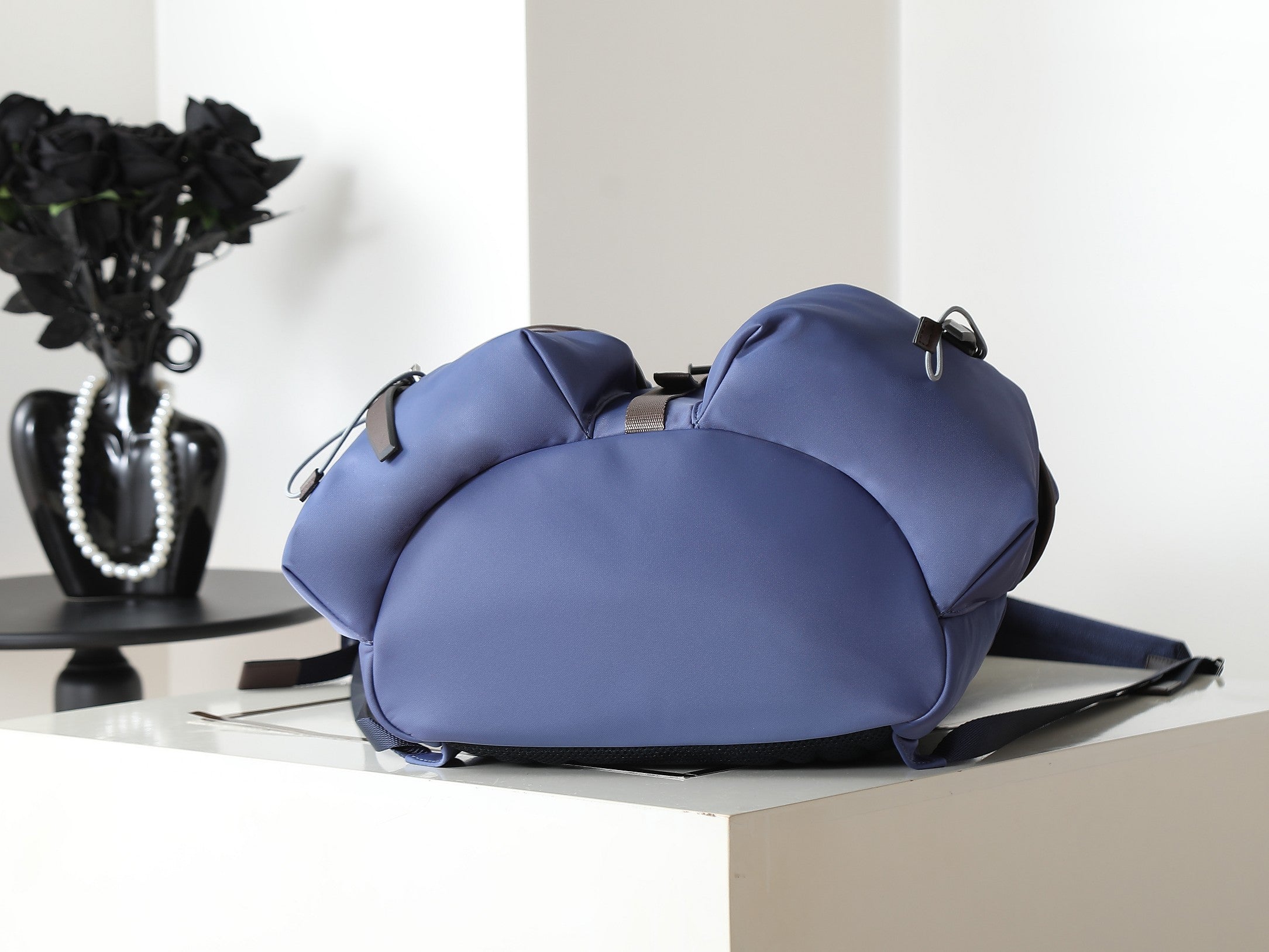 Prada blue nylon duffel-style bag with rounded shape, top handles, straps