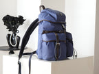 Prada blue nylon backpack from side angle with adjustable shoulder strap