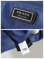 Prada Made in Italy tag and size label on blue nylon backpack