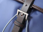 Prada blue bag with brown leather trim and silver buckle strap detail