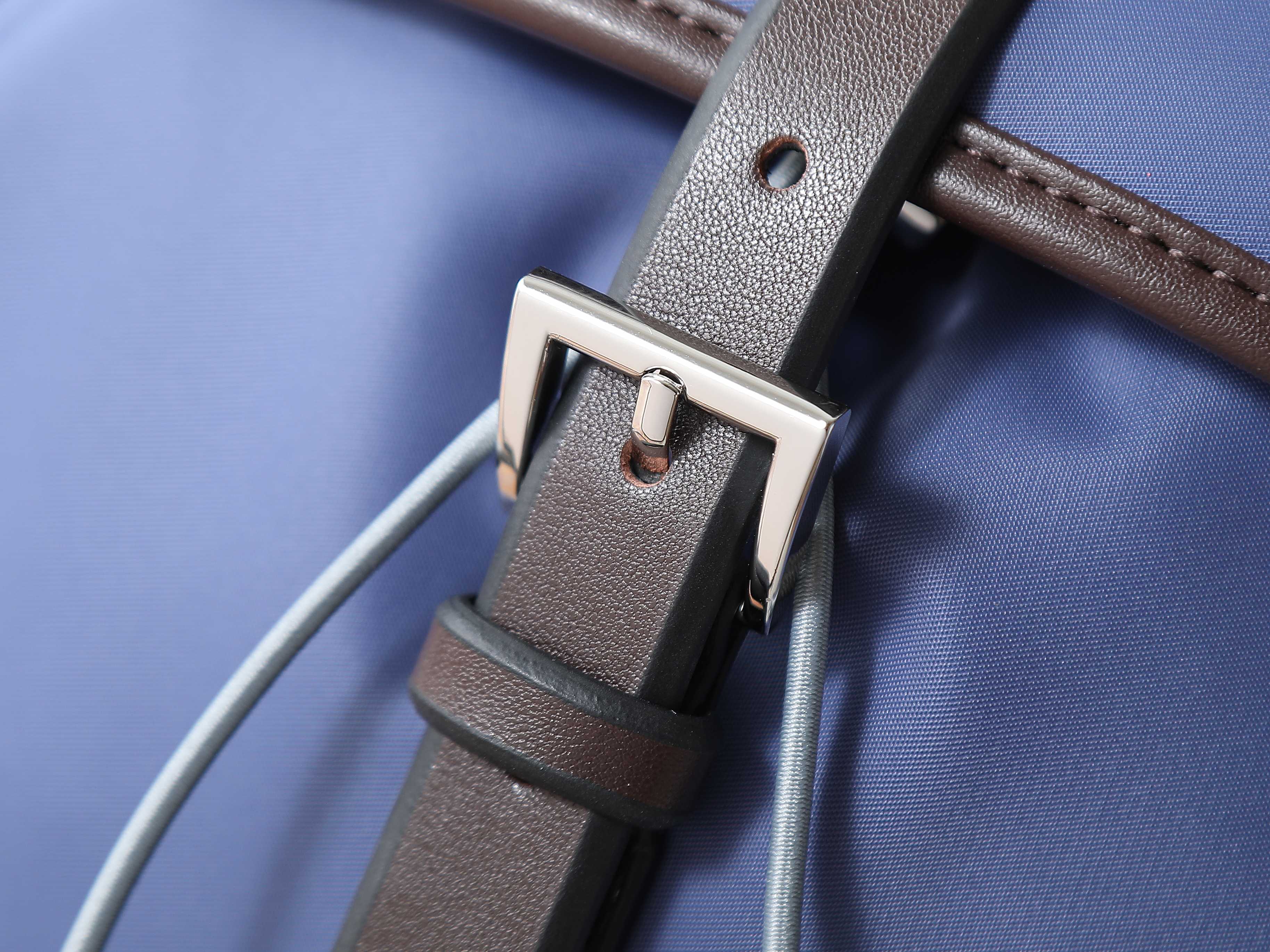 Prada blue bag with brown leather trim and silver buckle strap detail