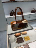 Patchwork leather bag on display with top handles, multicolor front panels, and visible zip detail.