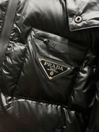 Black long puffer jacket chest pocket with Prada logo patch and snap button