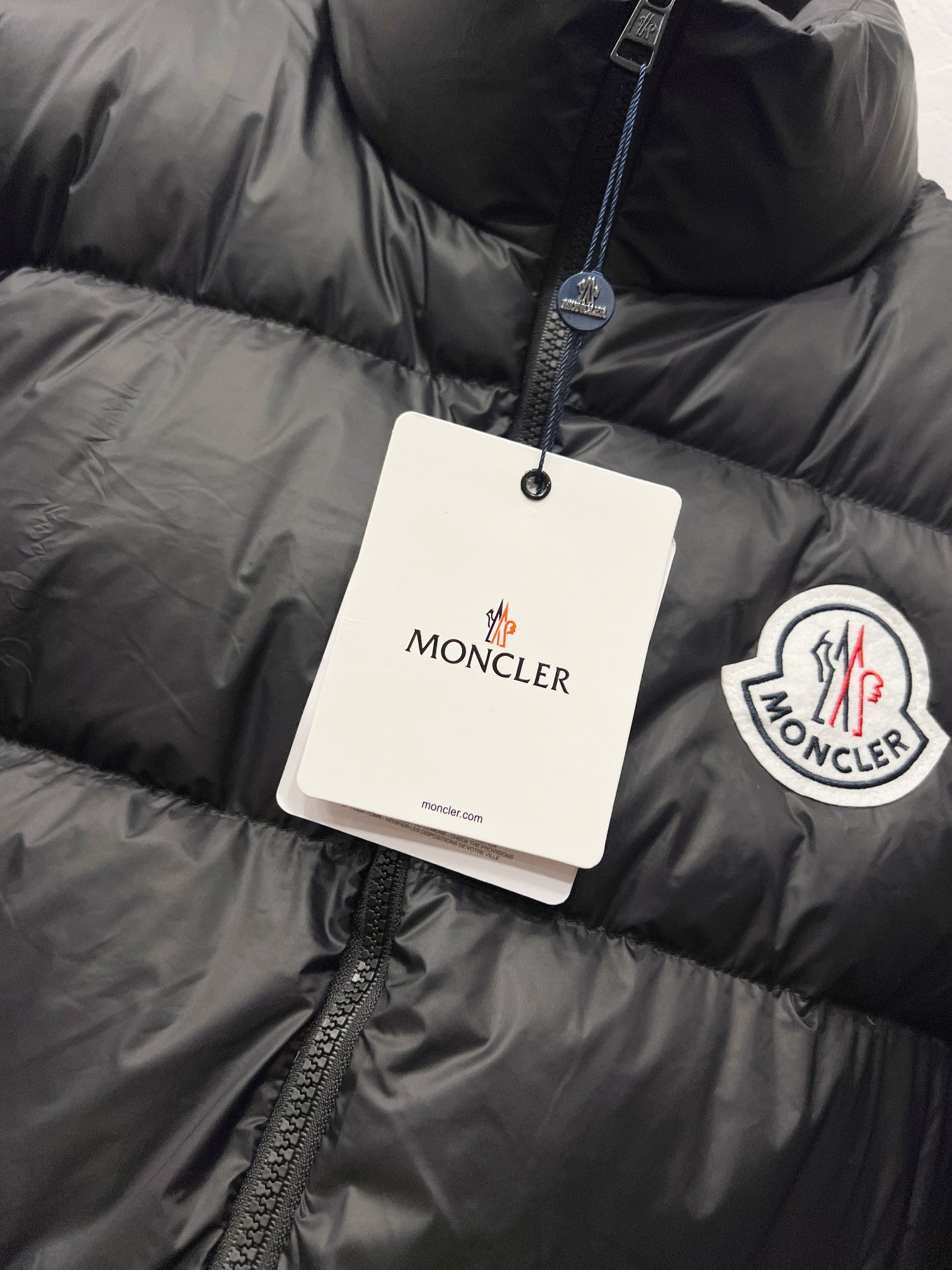 Moncler puffer jacket with hanging tags and chest logo patch