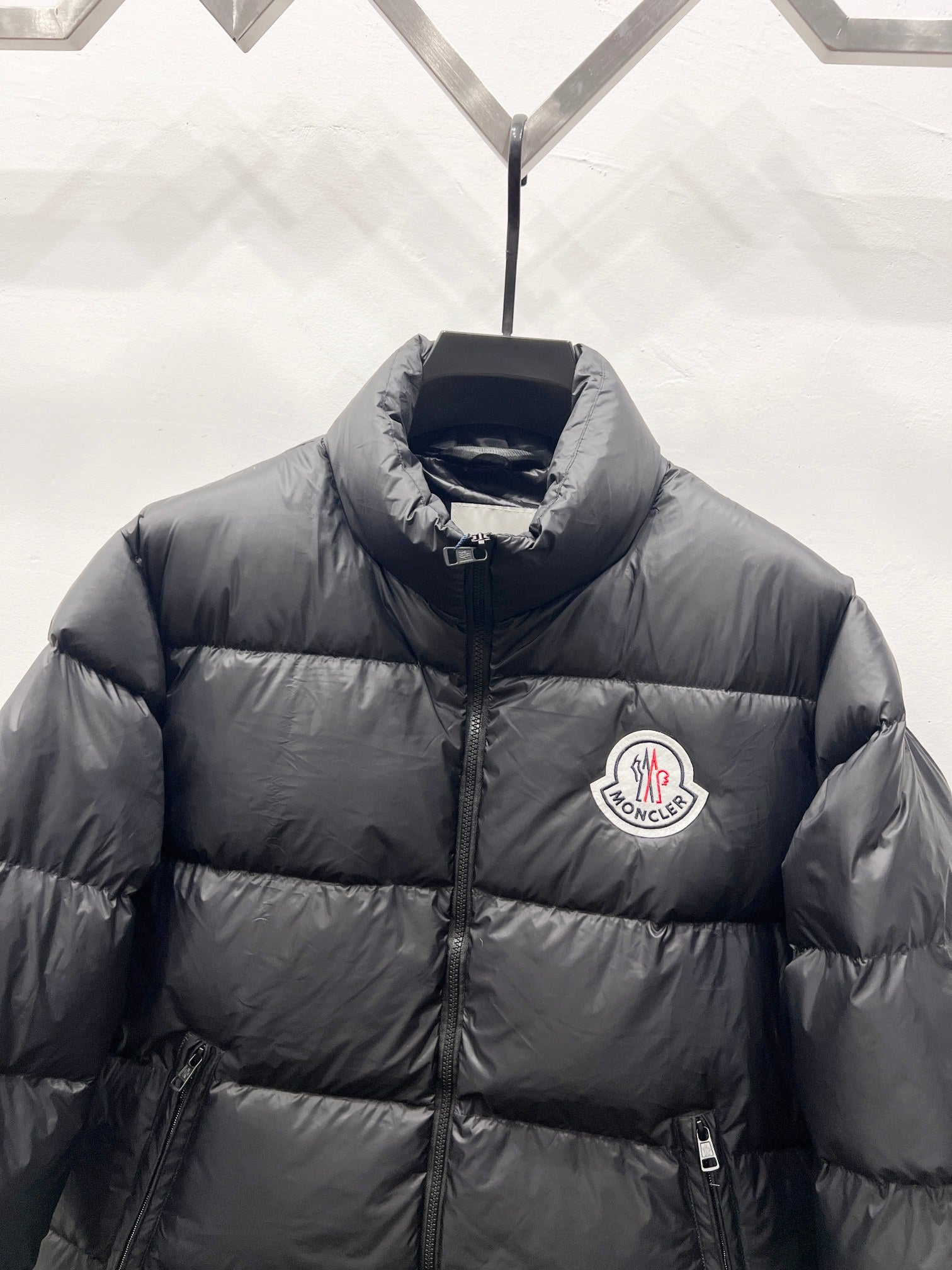 Moncler long puffer jacket with chest logo patch and stand collar