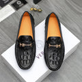Black leather loafers with embossed texture and gold-tone buckle details, cushioned soles.