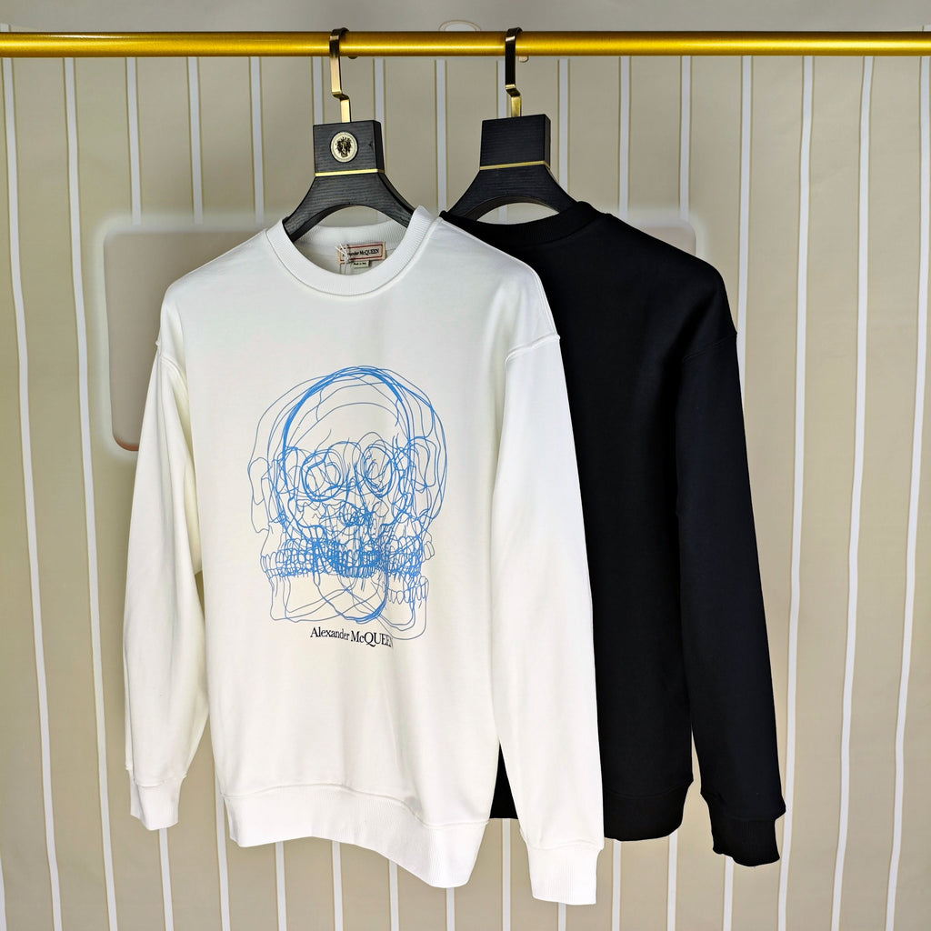 White and black crewneck sweatshirts on hangers; white has blue skull graphic