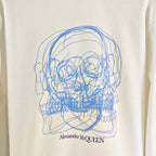 White sweatshirt with large blue line-art skull graphic and Alexander McQUEEN text