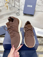 Brown knit sneakers with lace-up closures and white rubber soles